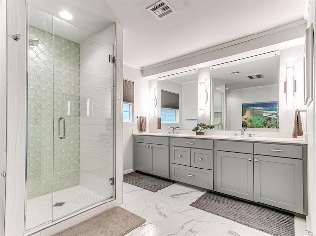 bathroom with ornamental molding, a stall shower, and visible vents