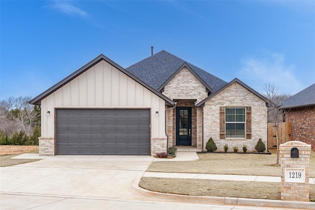 view of front of house featuring driveway, board and batten siding, an attached garage, a shingled roof, and brick siding