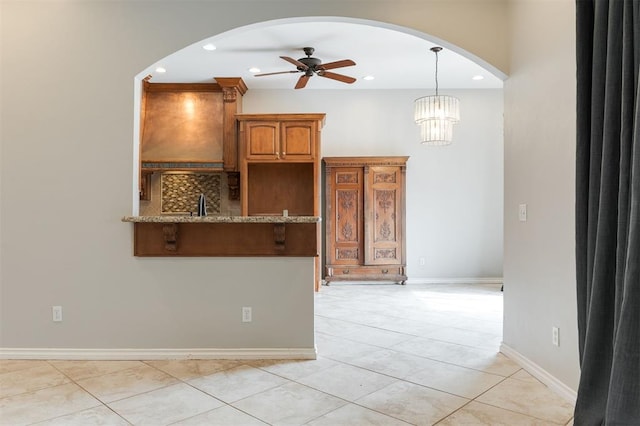 interior space featuring recessed lighting, ceiling fan, baseboards, and light tile patterned floors