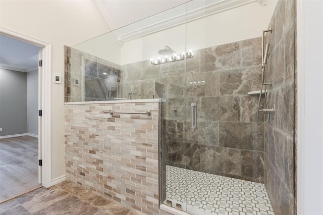 full bath with ornamental molding, a stall shower, and baseboards