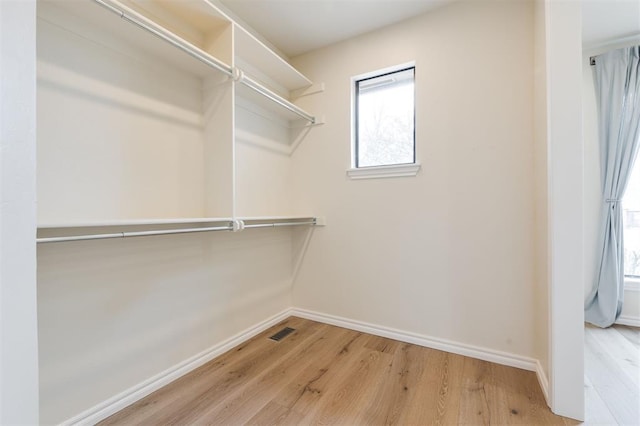 walk in closet featuring wood finished floors and visible vents