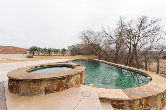 view of swimming pool featuring a pool with connected hot tub