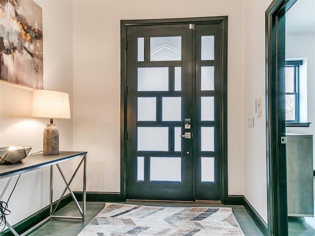 entryway with baseboards and a healthy amount of sunlight