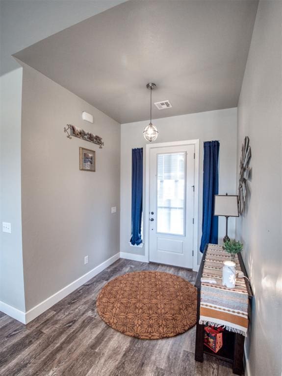 entrance foyer featuring visible vents, baseboards, and wood finished floors