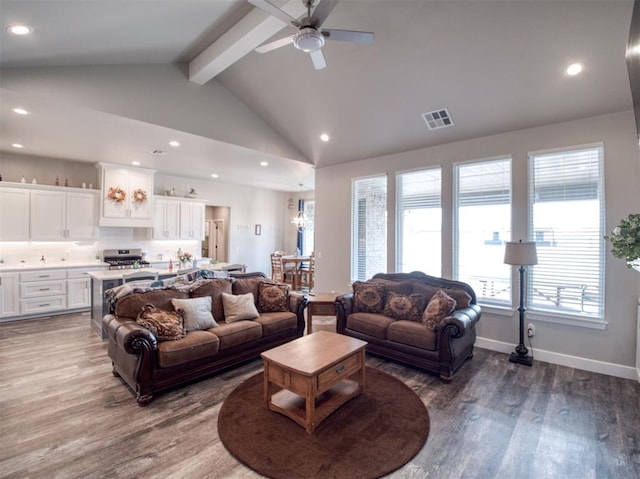 living room with visible vents, beamed ceiling, baseboards, and wood finished floors