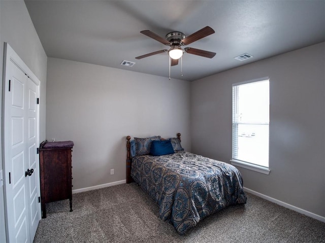 carpeted bedroom with a ceiling fan, baseboards, and visible vents