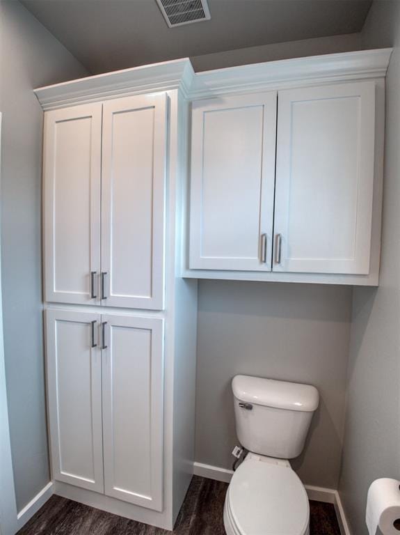 bathroom with visible vents, baseboards, and toilet