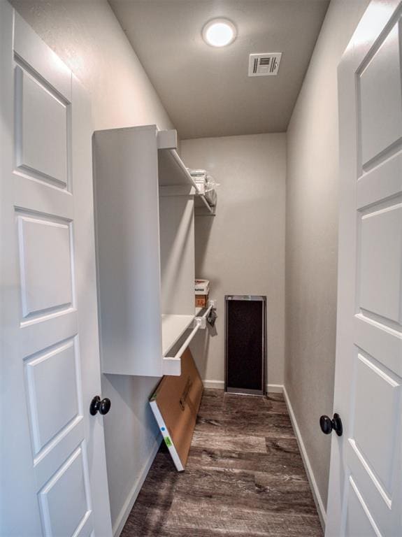 spacious closet featuring visible vents and dark wood-style flooring