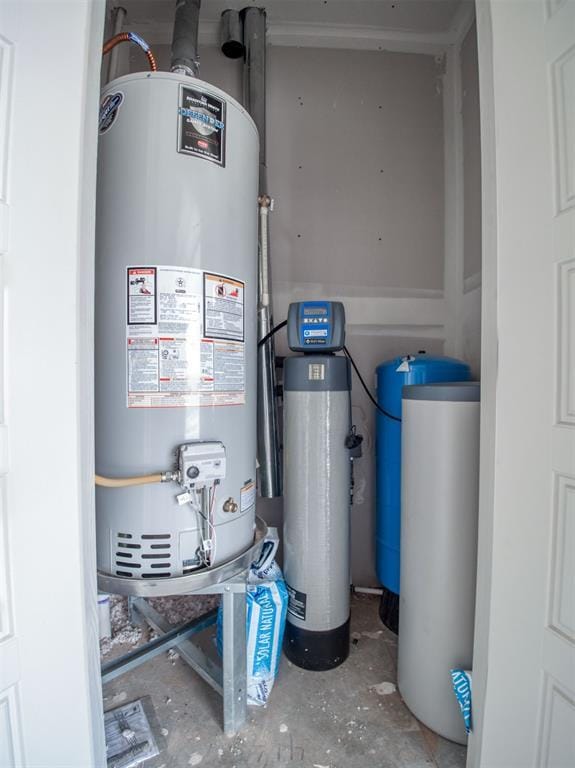 utility room featuring gas water heater