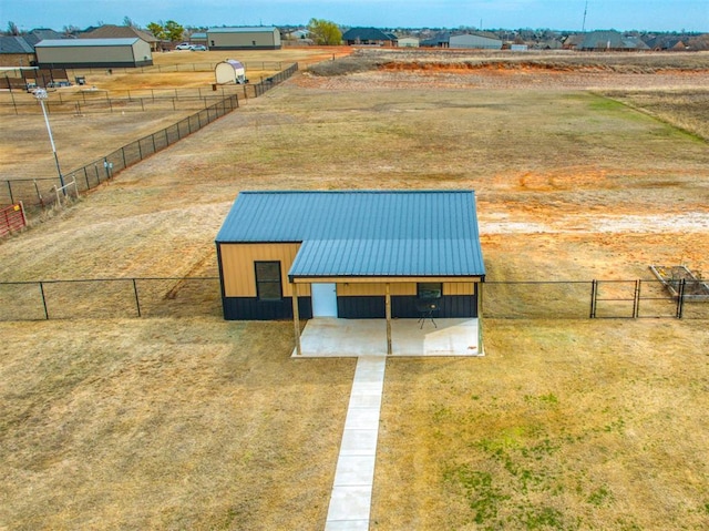 birds eye view of property with a rural view