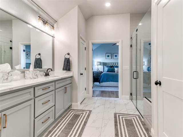 ensuite bathroom featuring marble finish floor, a shower stall, connected bathroom, and vanity