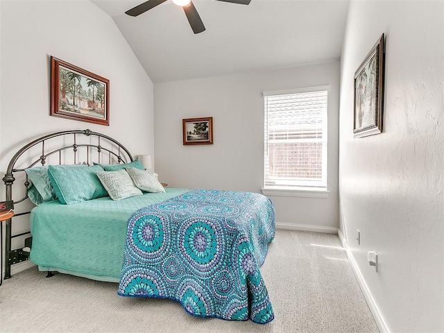 carpeted bedroom featuring ceiling fan, baseboards, and vaulted ceiling