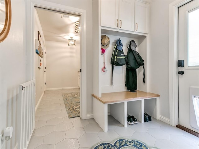 mudroom featuring light tile patterned flooring and baseboards