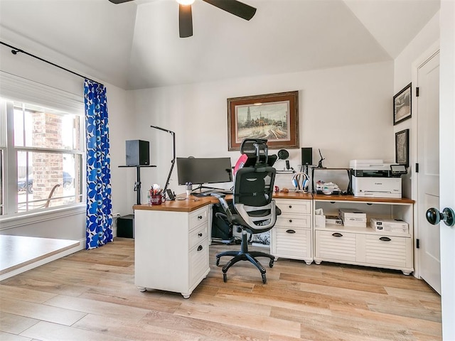 home office with lofted ceiling, light wood-style floors, and a ceiling fan