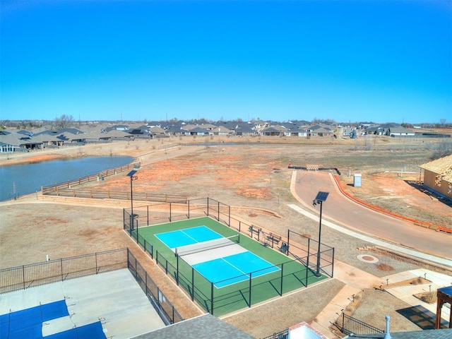 drone / aerial view featuring a water view and a residential view