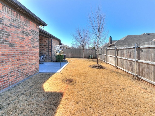 view of yard featuring a patio area and a fenced backyard