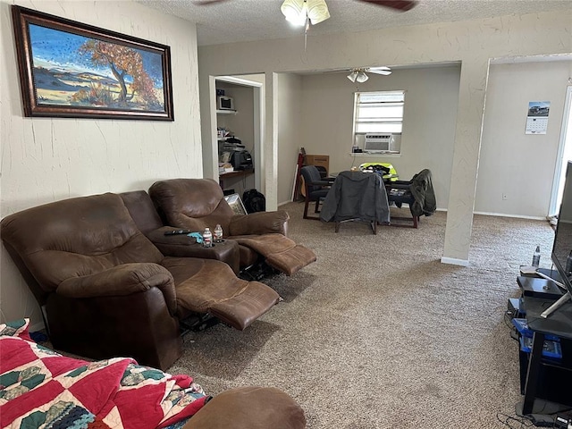 living area featuring carpet floors, a textured wall, a ceiling fan, a textured ceiling, and cooling unit