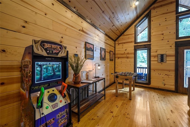 game room featuring wood ceiling, wooden walls, plenty of natural light, and light wood-style floors