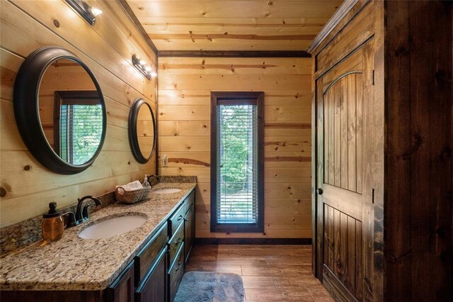 full bathroom with a sink, wood-type flooring, and wooden walls