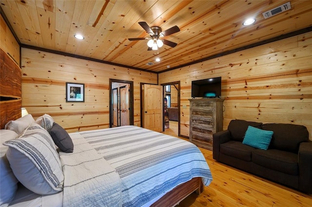 bedroom with wooden walls, visible vents, light wood-style flooring, recessed lighting, and wood ceiling