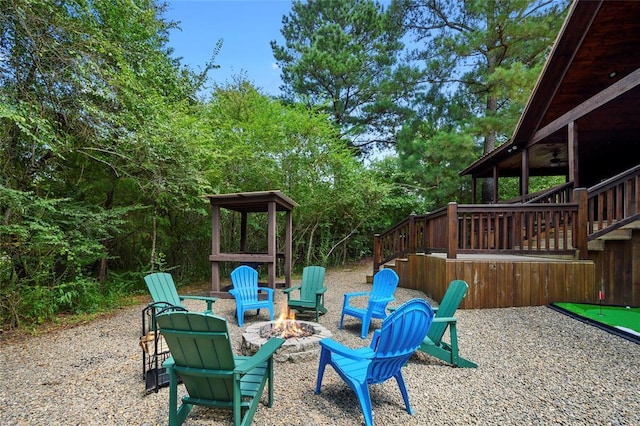 view of yard with a patio, ceiling fan, and an outdoor fire pit