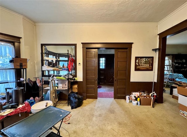 interior space with a textured ceiling and ornamental molding