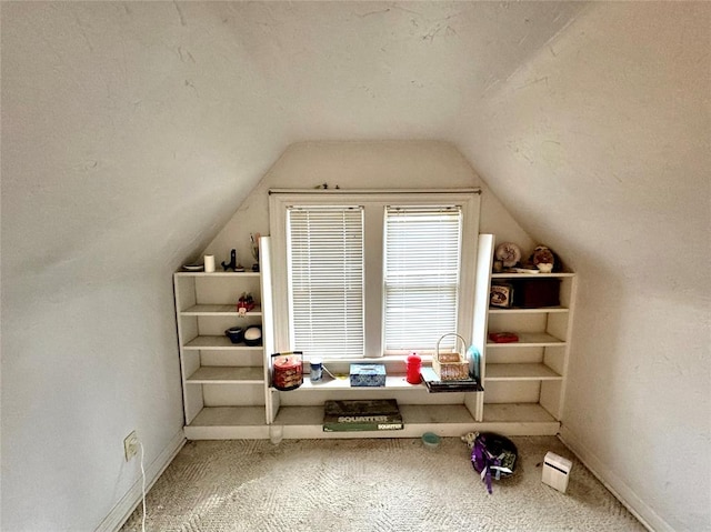 bonus room with baseboards, lofted ceiling, and carpet