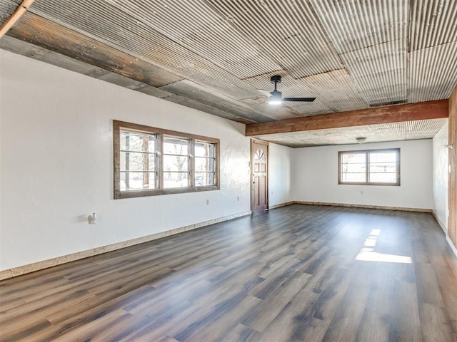 empty room featuring ceiling fan, wood finished floors, and baseboards