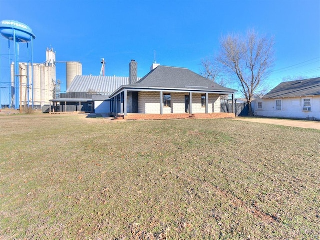 view of front of home featuring a front yard and a chimney