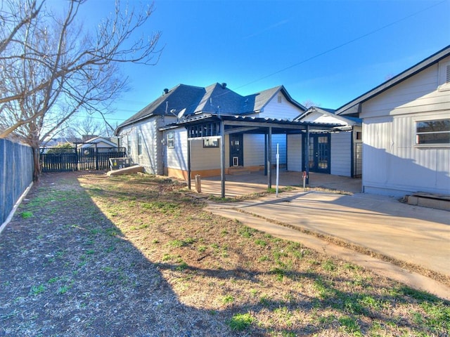 back of house with a patio area, a fenced backyard, and a pergola