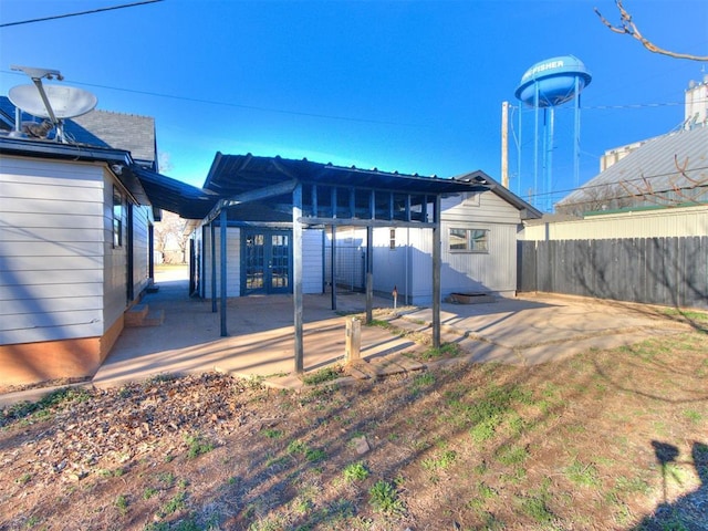 back of property with fence, a pergola, a patio, and french doors