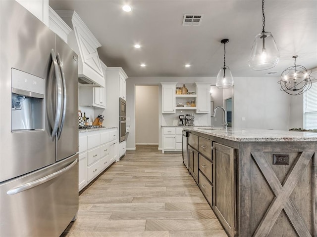 kitchen with stainless steel appliances, a sink, visible vents, white cabinetry, and open shelves