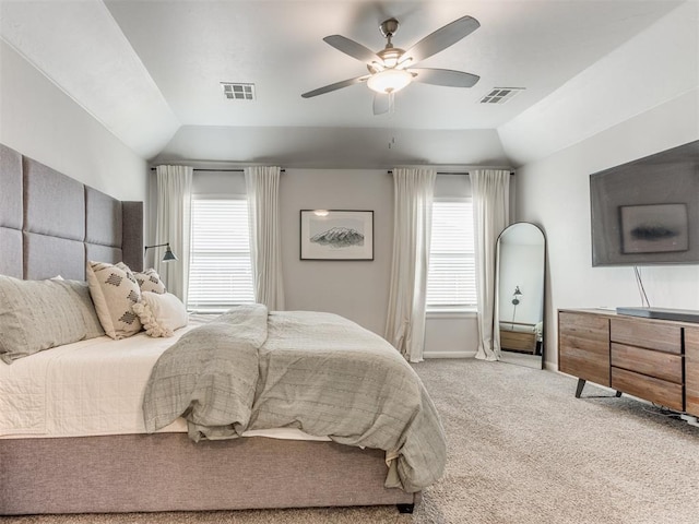 bedroom featuring lofted ceiling, visible vents, carpet flooring, and multiple windows