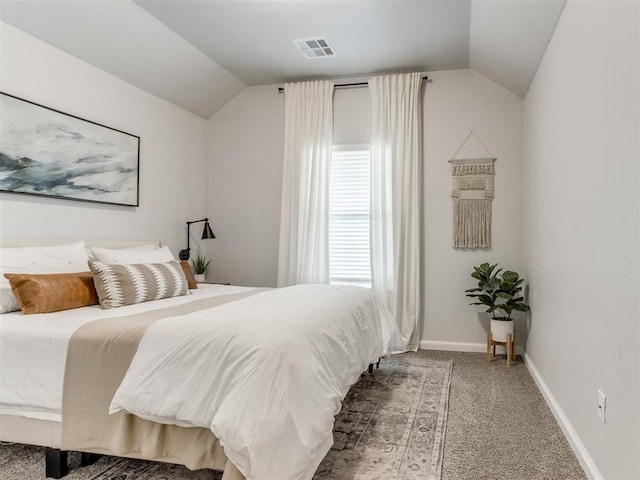 carpeted bedroom with lofted ceiling, visible vents, and baseboards