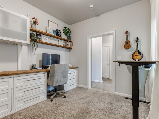 home office with light carpet and baseboards