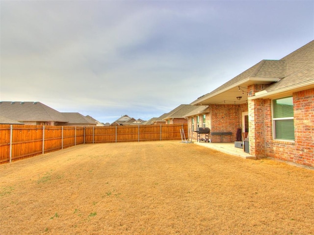 view of yard with a patio and a fenced backyard