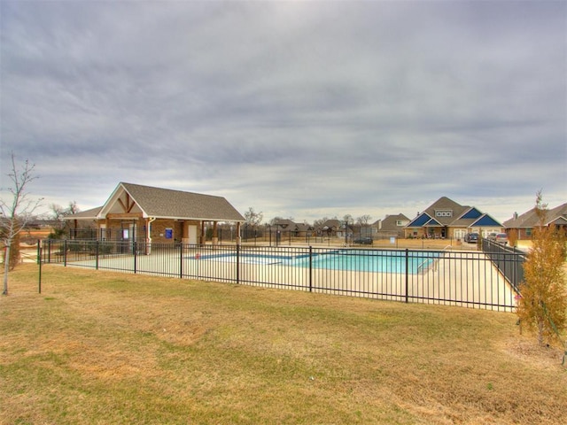 community pool featuring a yard, a patio, and fence