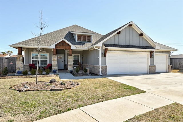 craftsman inspired home featuring a garage, concrete driveway, roof with shingles, fence, and a front yard