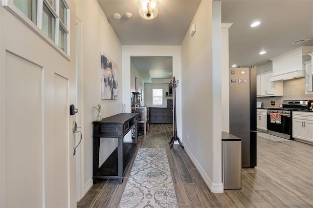 foyer featuring recessed lighting, baseboards, visible vents, and light wood finished floors