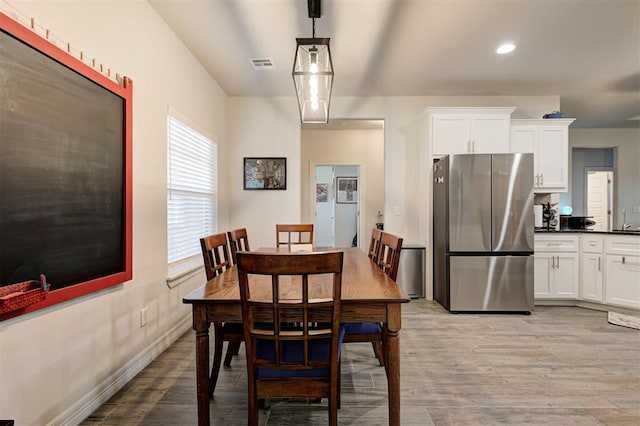 dining area featuring light wood-type flooring, visible vents, baseboards, and recessed lighting