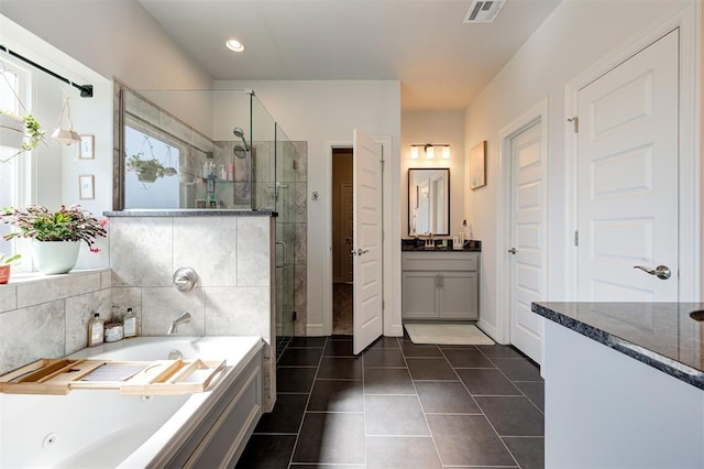 bathroom with visible vents, tile patterned floors, a whirlpool tub, vanity, and a shower stall