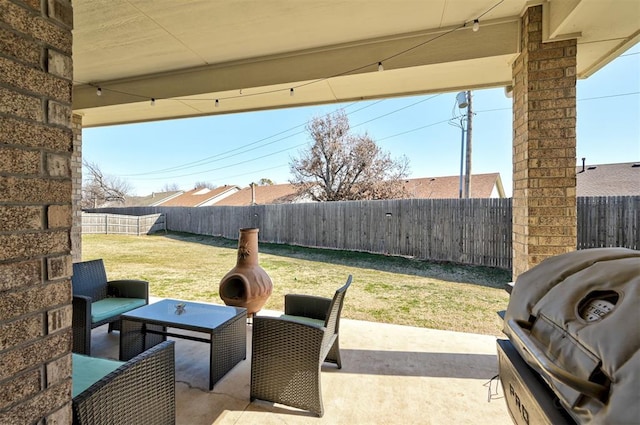 view of patio featuring a fenced backyard and a grill