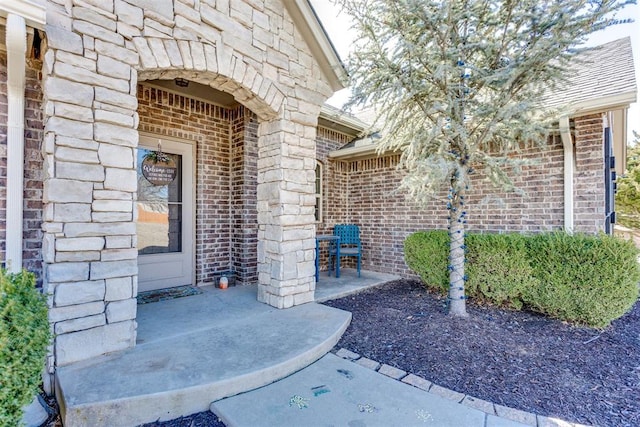 entrance to property with stone siding and brick siding