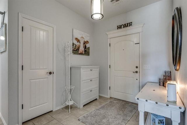 foyer featuring light tile patterned floors and visible vents