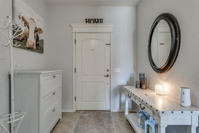 entryway featuring light tile patterned floors and baseboards