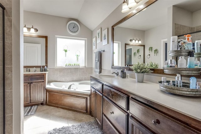 bathroom with tile patterned flooring, vanity, vaulted ceiling, a tile shower, and a bath