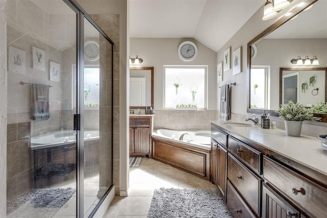 full bathroom featuring a garden tub, a stall shower, vaulted ceiling, vanity, and tile patterned floors