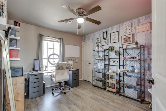 office featuring baseboards, ceiling fan, visible vents, and wood finished floors