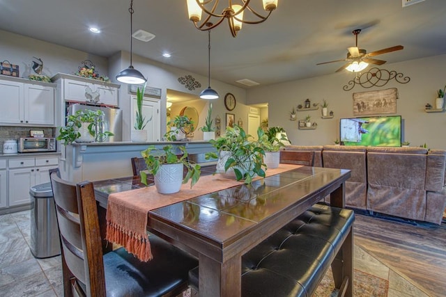 dining room with recessed lighting, a toaster, visible vents, and ceiling fan with notable chandelier