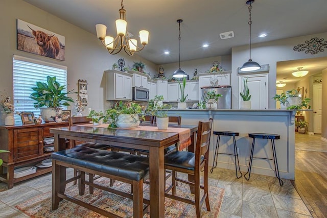 dining space with visible vents, a chandelier, and recessed lighting